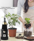 Soil And PH Meter With High Sensitivity Alloy Probe For Accurate PH And Humidity Readings Ideal For Outdoor Plants Gardens And Farms Compact Lightweight Design No Batteries Required Quick Easy Battery Free Plant Health Checks next to potted plants on a table
