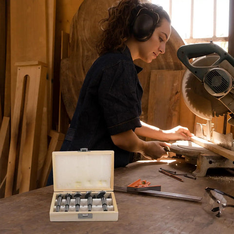 Knockout 5 Piece Forstner Bit Set For Woodworking That Booms With Precision, wooden case displayed with bits in a workshop.