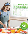Woman using Handheld Vacuum Sealer With 35 Reusable Bags Automatic OneTouch Seal Keeps Meat Fish Veggies Nuts And Coffee Fresh