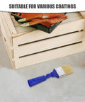 Blue-handled 2 Inch Adjustable Angled Paint Brush for Fine Detail and Corners near wooden crate