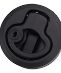 Close-up of black flush-mount round boat hatch latch with locking lever and keyhole