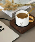 Smart Cup Heater And Mug Warmer With Three Adjustable Levels And Auto Timing Off Keeps Your Daily Brew Piping Hot On A Slim Chocolate Electric Heating Coaster with a coffee mug.