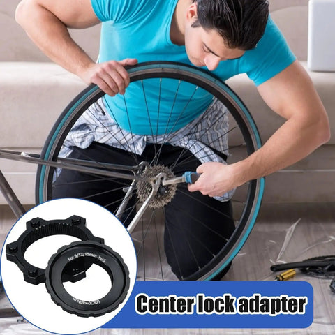 Man fixing bike wheel with Center Lock Adapter For Bikes Lightweight Aluminum Disc Brake Rotor Upgrade Ride Ready Rotor.