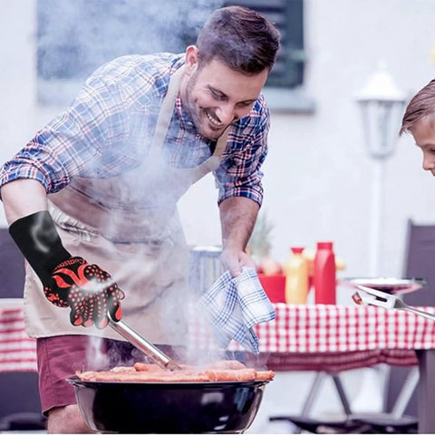 Man using Heat Resistant BBQ Grilling Gloves For Men And Women Up To 1472F With Meat Thermometer Probe Auto Off grilling outdoors.
