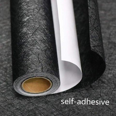 Close-up of roll of Slick Self Adhesive Black Silk Wallpaper Peel And Stick With Embossed Texture For Walls Cabinets And Furniture
