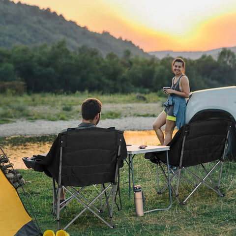 Oversized XL Camping Chair For Adults Built Tough 500 Lb Capacity with padded headrest and cup holder at campsite during sunset