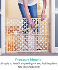 Person installing Wooden Baby Gate With Mesh For Doorways, Quick Fit Pressure Mounted, Adjustable From 26.5 To 42 Inches Wide