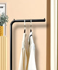 Matte Black Metal Coat Rack Dope Modern Clothing Tree With Heavy Slate Base featuring plant hanger in a stylish interior