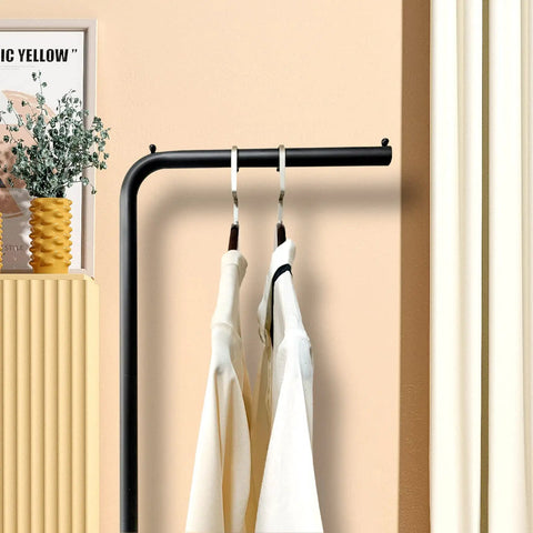 Matte Black Metal Coat Rack Dope Modern Clothing Tree With Heavy Slate Base featuring plant hanger in a stylish interior