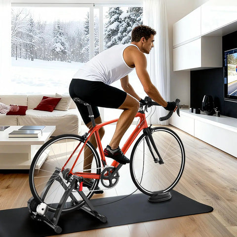 Man using 6 Level Magnetic Bike Trainer With Adjustable Resistance For Indoor Cycling Fits 26-28 Inch And 700C Wheels in living room