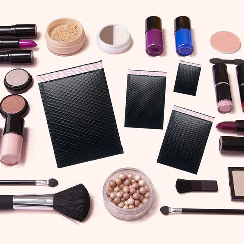 Black Bubble Mailers 8.5x12 Inches 25 Pack Padded Shipping Envelopes With Ultra Strong Adhesive shown with makeup items