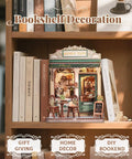Sunny Cafe Book Nook Kit DIY Cozy Miniature House decor with LED light on wooden shelf, surrounded by books, perfect gift display.