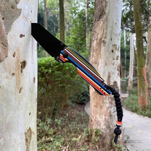Knife with pearl resin handle slabs, DIY knifemaking, polymer scale grips, outdoors against tree