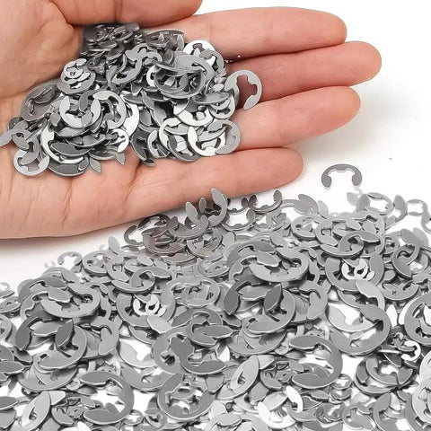 Hand holding stainless steel E clips from 120 Piece Shaft External Retaining Ring E Clips Kit 1.5mm To 10mm Stainless Steel Snap Circlips Washer