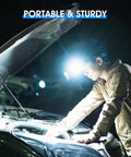 Person using Adjustable Headlamp Bracket With Black Headlamp Strap and Hand Strap for tools during night vehicle repair.