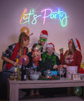 Group celebrating under RGB Lets Party Neon Sign For Wall Decor Large LED Neon Light Up Sign With Rainbow Colors And Music Sync
