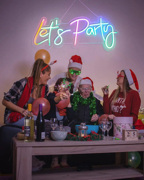Group celebrating under RGB Lets Party Neon Sign For Wall Decor Large LED Neon Light Up Sign With Rainbow Colors And Music Sync