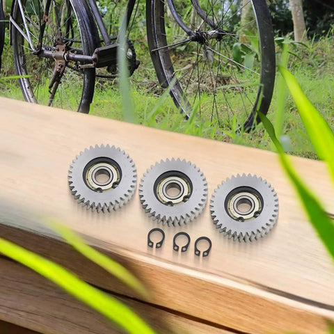 3 Pack E Bike Planetary Gear Kit with 36 Tooth Helical Gears 38mm Steel Plastic Motor Gears on a wooden surface outdoors