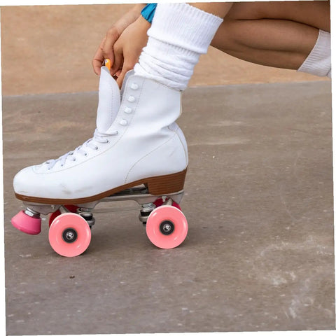 Close-up of white roller skate with 4 pack roller skate wheels with bearings double row outdoor quad skating wheels in pink.