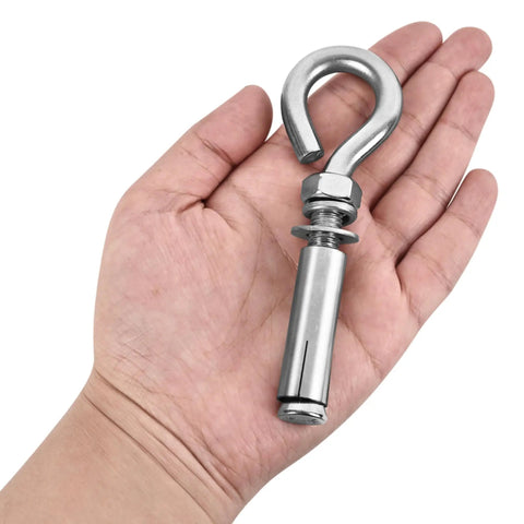 Heavy Duty Expansion Eye Bolts Four Pack With Drill Bit For Concrete Walls Built Tough As Nails Pro Grade Masonry Anchors in hand.