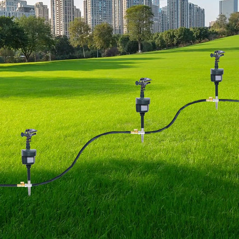 Three motion activated lawn sprinkler deterrents for cats, dogs, and birds with 360 degree adjustable head in green field