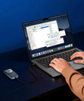 User transferring files on a laptop with Ridiculously Fast M.2 NVMe SSD Enclosure With Built In Quiet Cooling Fan.