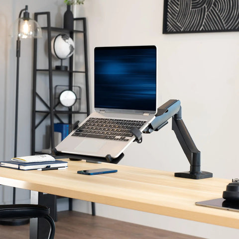 Built Tough Adjustable Laptop Desk Mount For 10 To 15.6 Inch Notebooks With Heavy Duty C Clamp and Grommet Vesa Bracket Support Up To 9.9 Lbs Single Smooth Pivot Arm Matte Black Finish on desk.
