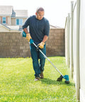 Man using a 13-Inch Cordless String Trimmer With Brushless Motor, 18V LXT, No Gas Emissions, Low Noise Design on grass by fence.
