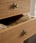 Top Shelf Antique Brass Cabinet Knobs With Quatrefoil Backplate on wooden drawer, vintage style, six pack.