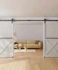 12 Foot Sliding Barn Door Hardware Kit Fits Double Doors Up To 36 Inch Wide Heavy Duty Carbon Steel Track With Premium Ball Bearings Rust Resistant Black Powder Coat And Quiet Smooth Nylon Wheels Easy To Install Doors Not Included installed in a living room with white doors