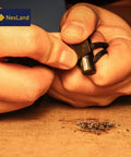 Hands using Ceramic Striker Fire Starter Necklace With Ferro Rod Toggle And Paracord All In One Bushcraft Emergency Fire Starter Kit.