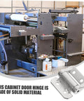 One silver metal cabinet door hinge with damping mechanism; heavy-duty, shown against an industrial machine