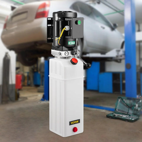 Front view of white VEVOR 6-quart hydraulic power unit with black motor atop reservoir in auto shop.