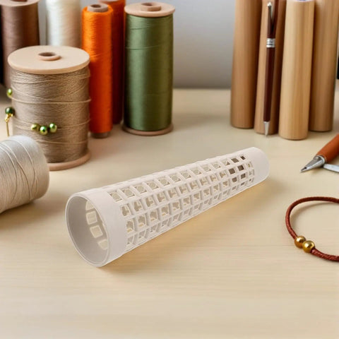 Plastic Yarn Bobbins Set Of 20, Tapered Tower Spools Made From PP Material To Prevent Tangling And Surface Damage, Ideal For Dyeing, Steaming, Bulk Textile Production And Sewing Supplies. White openwork PP yarn bobbin shown on a worktable