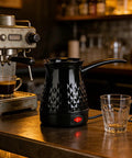 Go To Turkish Coffee Maker 600Ml Electric Pot With Even Heating Removable Anti Scald Handle Spill Proof Pour Spout Ideal For Turkish Greek Arabic Tea Milk Or Butter Quick Brew For Fresh Flavor Every Morning, on a kitchen counter next to a glass cup.