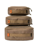 Stacked khaki packing cubes in S, M, L, made from waterproof 500D nylon. Durable Travel Packing Cubes Set With Zippers Luggage Organizers For Backpacking.
