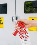 Person demonstrating 8 Pack Lockout Tagout Hasp Kit With 1.5 Inch Extended Jaw Tamper Proof LOTO Hasps on a locked electrical cabinet.