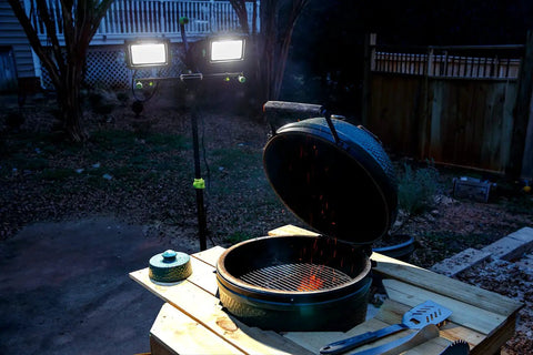 14,000 Lumen LED Work Light With All Metal 60 Inch Telescoping Tripod Stand illuminating outdoor grill scene