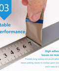 Image of DATMXXD High Temp PTFE Tape Rolls being peeled off a ruler, demonstrating strong adhesion and no residue.