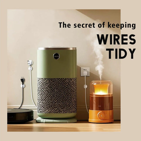 A green air purifier, humidifier, and vacuum cleaner on a wooden floor with cords neatly organized using wall clips.
