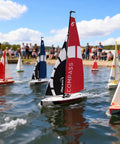 53 Inch Remote Control Sailboat Kit With Pre Assembled Sail Accessories sailing on a pond with multiple other model boats
