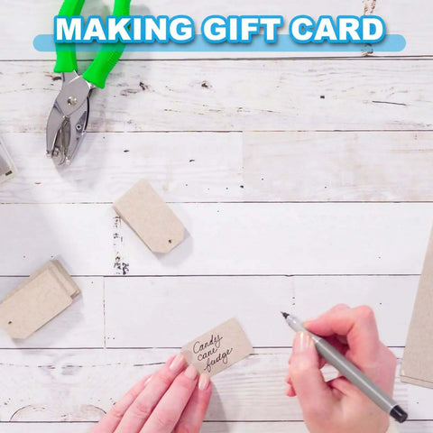 Three Piece Handheld Paper Hole Punch Set With Soft Grip Handles in use for making gift cards, green handles visible on wood surface