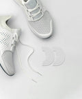 Tough As Nails Shoe Heel Pads 4Mm Thick Rubber Non Skid Adhesive Repair Kit with white sneakers on gray background.