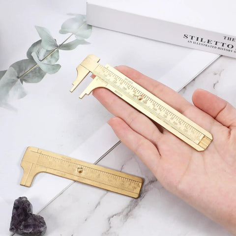 Hand holding Brass Pocket Vernier Caliper Set with 3.15 Inch and 3.94 Inch mini sliding calipers for jewelry measurement tool.