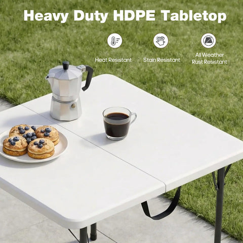 34 Inch Square Folding Table For Four With 330 Lbs Capacity Built Tough HDPE Top And Heavy Duty Steel Legs For Portable Indoor Outdoor Parties Camping White, set with coffee and pastries on a lawn.