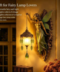 Fairy Lamp Vintage Wall Sconce, Hand-Painted Wing Design Dimmable，green with glowing globe and leaf accents on wall.