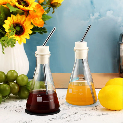 Two Pack Eight Point Five Ounce Glass Erlenmeyer Flasks for Cocktails and Coffee with Stainless Steel Straws on Table