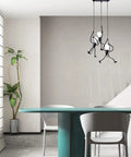 Swinging Man Pendant Light Fixture With Three Black Industrial Arms A Statement 3 Light Chandelier in dining area