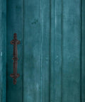 Rustic Cast Iron Outdoor Gate Handle With Knob Pulls For Garden Fence And Cabinet Hardware mounted on teal wooden gate