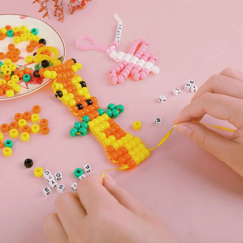 Hands weaving pony beads and letter beads from Beads For Crafts Kit With 12 Design Pony Beads And Letter Beads, Keychain Making Set